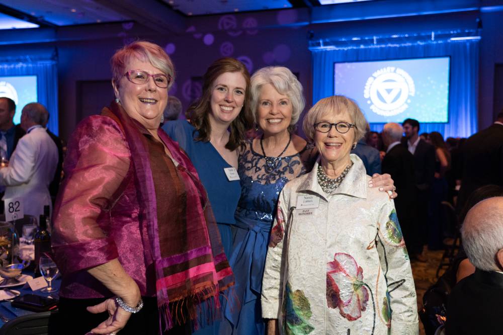 Marcia Haas and Nancy Lubbers posing with guests at Enrichment.